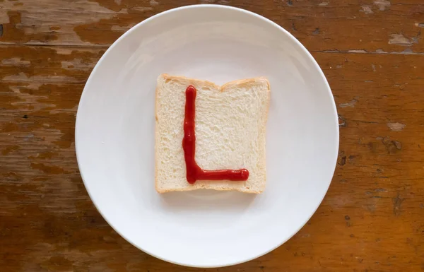 bread of breakfast is written L by ketchup on write plate. A to Z and Number and Special characters set.