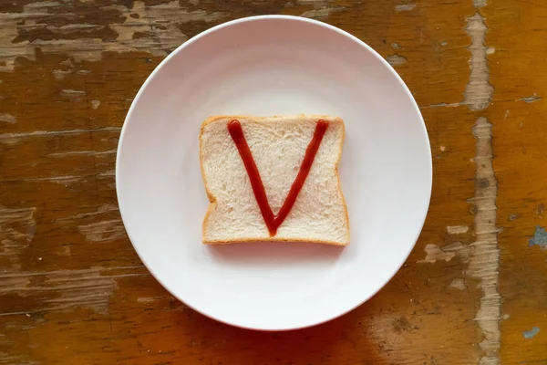 bread of breakfast is written V by ketchup on write plate. A to Z and Number and Special characters set.