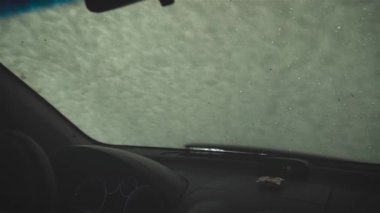 Araç temizleme hizmetlerinde aktif sıvı sabun ile ön camda içeriden görüntüle