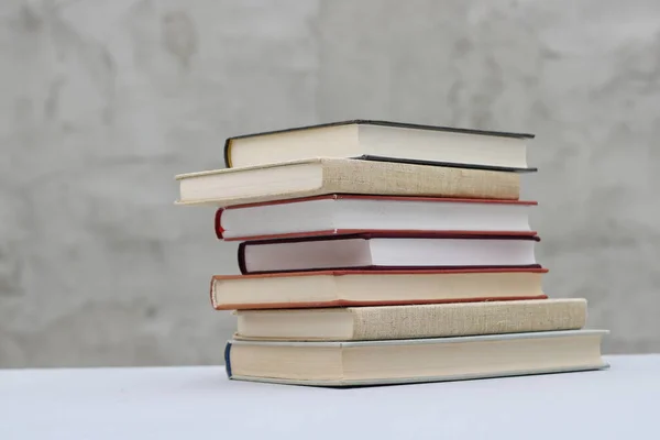 stock image Stack of books on gray background