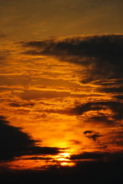 Sunset among the clouds over the mountains