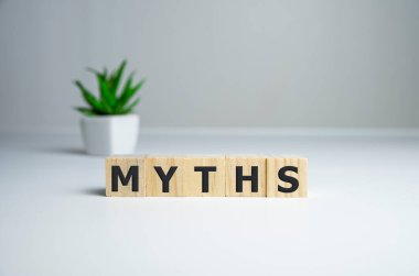 Myths word on wooden cubes. Myths concept. clipart