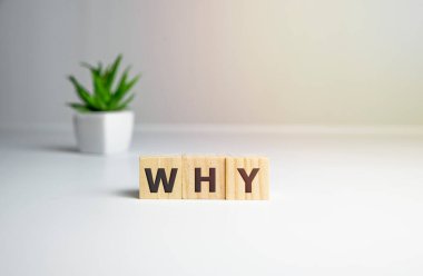 Letter block in word why on wood background.