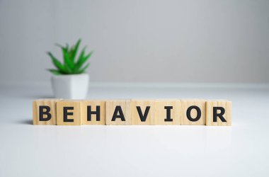 Word BEHAVIOR made with wood building blocks,stock image. clipart