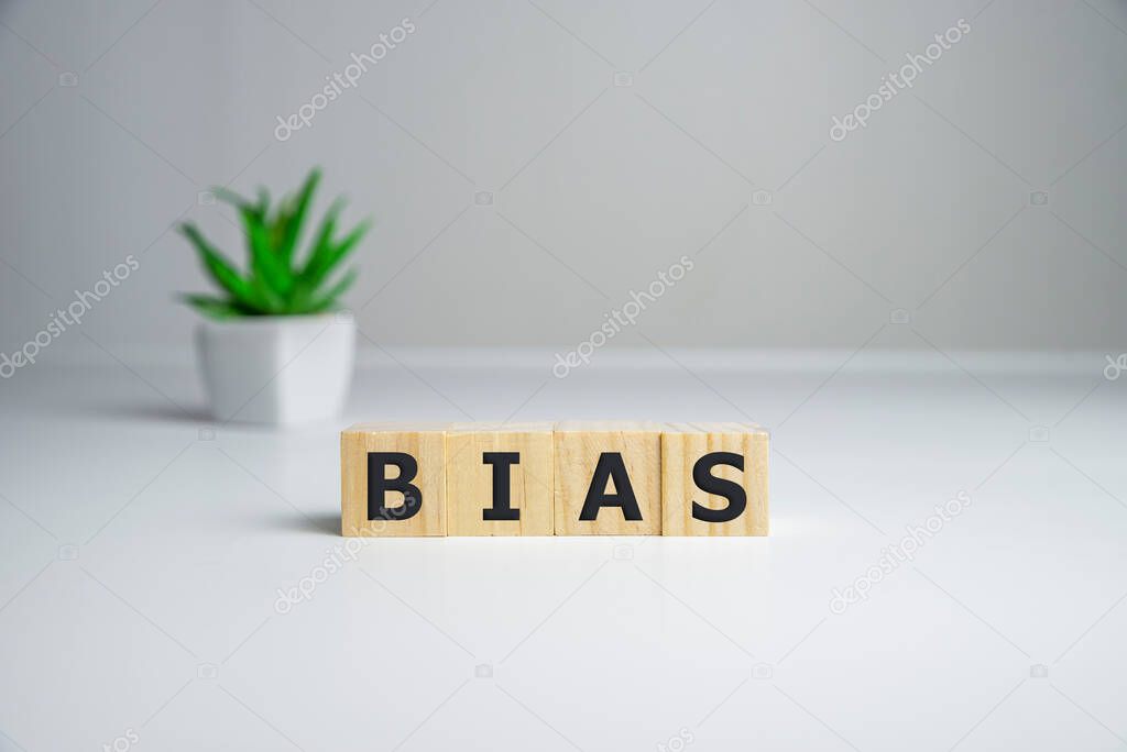 Bias - word from wooden blocks with letters, personal opinions prejudice bias concept, white background.