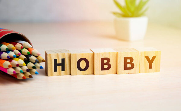 HOBBY word written on wooden blocks with collor pencils
