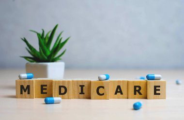 MEDICARE word made with building blocks, medical concept background. clipart