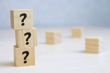 Tahta kübün blok şekli ve tahta masanın üzerinde işaret işareti işareti var..