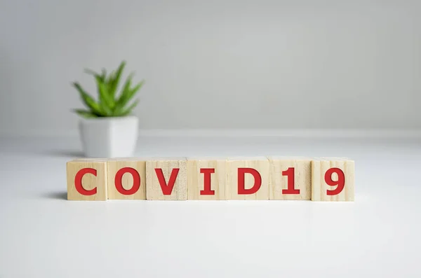 Inscription COVID-19 on wooden cubes. World Health Organization WHO introduced new official name for Coronavirus disease named COVID-19