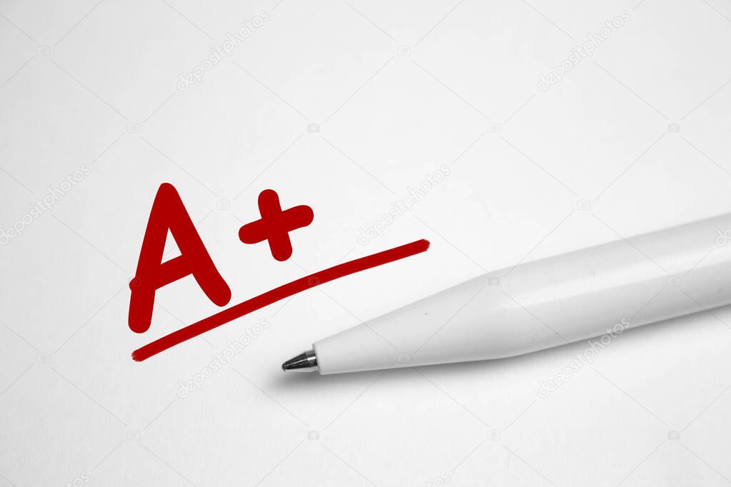 A plus A grade written in red pen on notebook paper