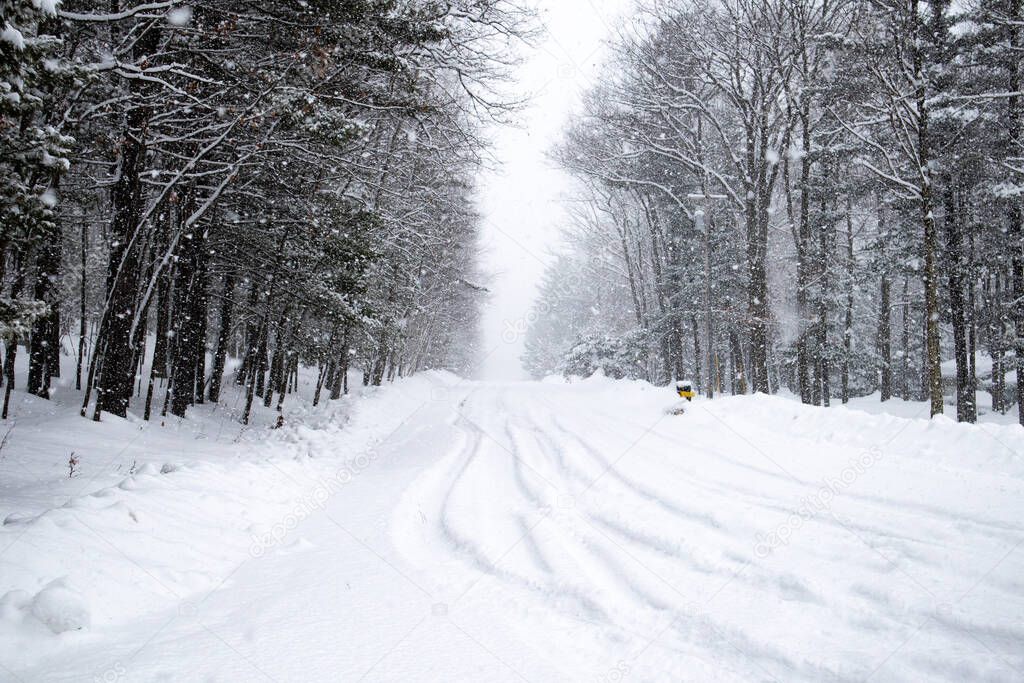 Snow covered road  in a February snowstorm in Wausau, Wisconsin getting one to two inchess an hour, horizontal