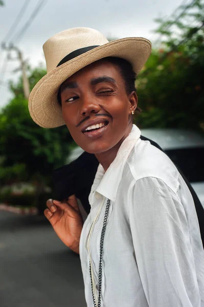 african girl with drawn mustache disguised as a man, cuba style