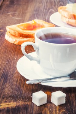 Fincan çay, ekmek, tereyağı ve reçel ile sağlıklı kahvaltı