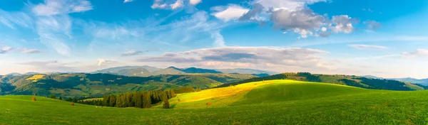 Panorama Carpathian mountain landscape with blue cloudy sky in summer