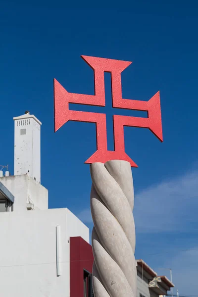 Red cross at church Igreja Matriz de Alvor. Building with a whit