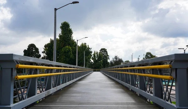 daylight metal pedestrian bridge