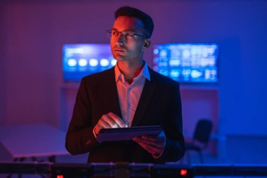 Gözlüklü işadamı tabletle çalışıyor.