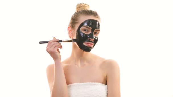 Woman Applying Black Face Mask White Background — Stock Video