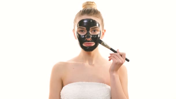 Happy Woman Applying Skin Care Black Mask White Background — Stock Video