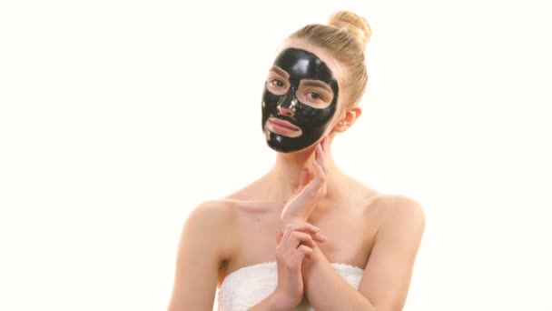 Happy Woman Black Face Care Mask Flirts White Background — Stock Video