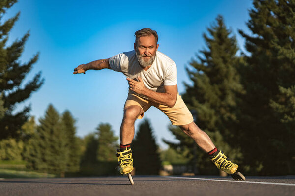 The old man rollerblading on the alley