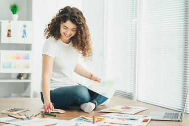 Masada oturan güzel sanatçı.