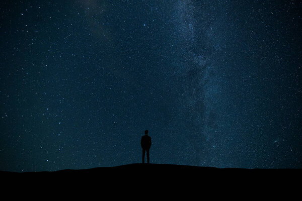 The male standing on the background of stars