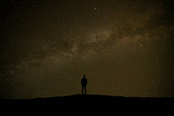 The man standing on the starry sky background
