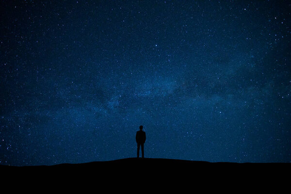The man standing on the starry sky background
