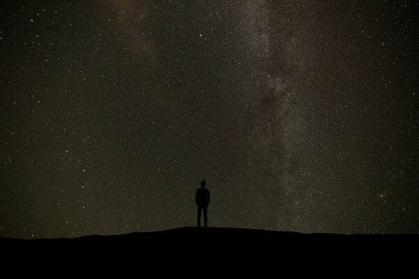 The man standing on the background of a sky with stars
