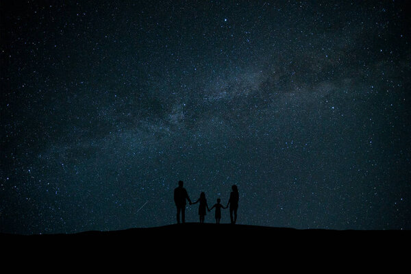 The family standing on the background of a starry sky
