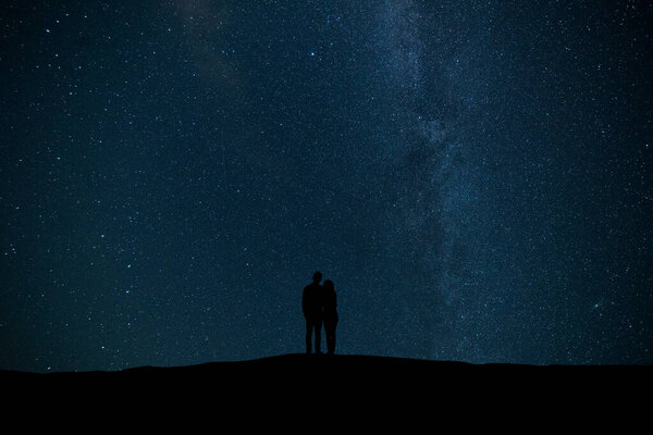 The couple standing on the starry sky background