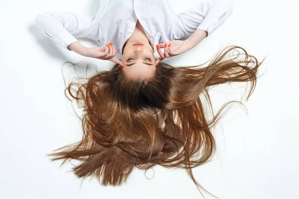 beautiful girl with very long hair on a white background