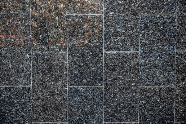 dark granite tiles in small gravel