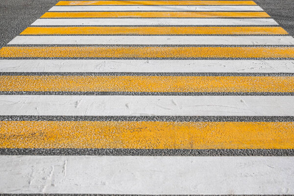 crosswalk on asphalt orange white