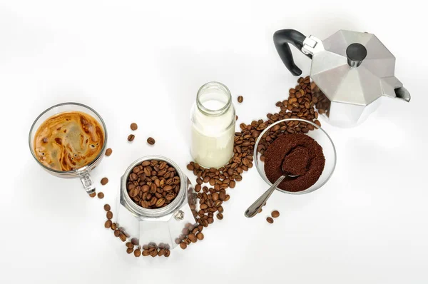 Coffee beans and ground, milk in a bottle, Moka pot
