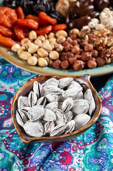 Traditional Azerbaijan sweet cuisine of holiday Nowruz. National dessert called Sumalak. Sprouted seeds with red ribbon