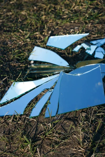 Pieces of broken mirror on the ground