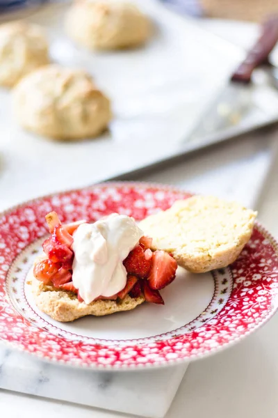 strawberry shortcake with cream on a cute plate.
