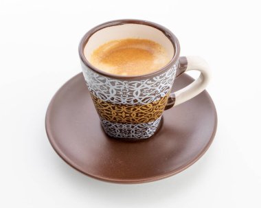 Kahverengi bir bardakta espresso ve sabah beyaz bir parmak izi.