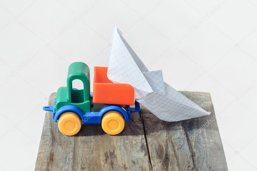 Toy truck unloads paper boat