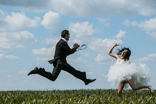 Happy bride and groom jump