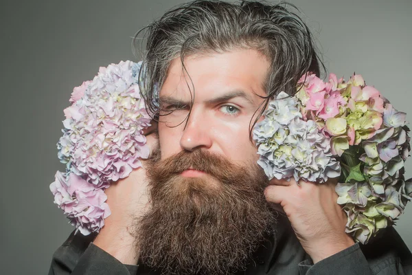 bearded man with hydrangea flowers