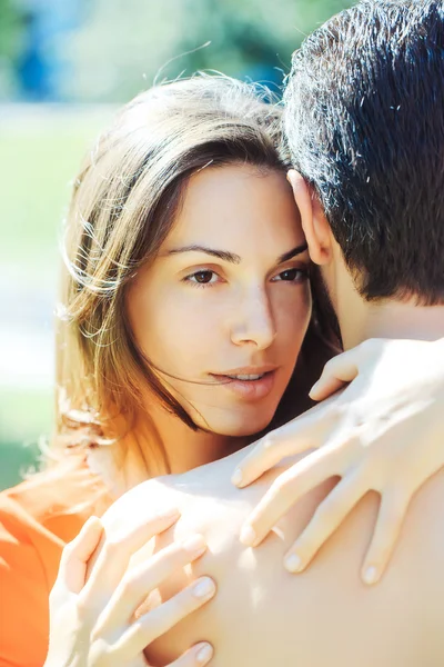 Pretty girl hugs muscular man — Stock Photo, Image