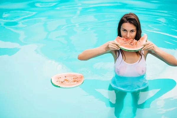 Mujer sexy con sandía en la piscina — Foto de Stock