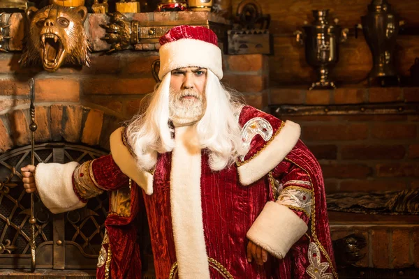 Santa Claus with fire iron — Stock Photo, Image