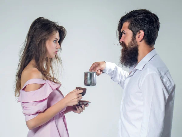 Young couple with coffee cup and pot — Stock Photo, Image