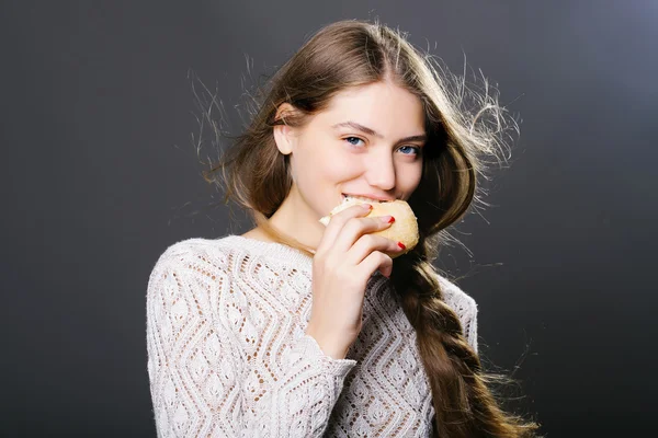 sexy young girl eating bread roll