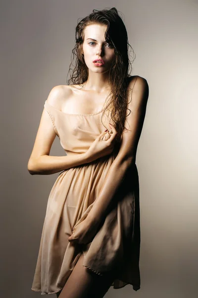 Pretty sexy girl in beige dress — Stock Photo, Image