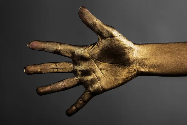 Vrouwelijke gouden hand — Stockfoto